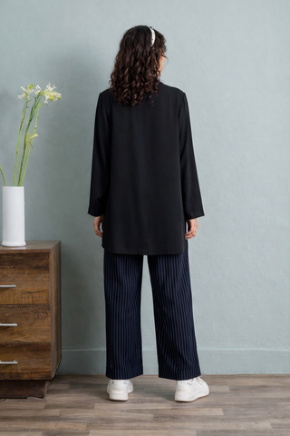 Effortless Elegance in Blue Tunic and Striped Trousers